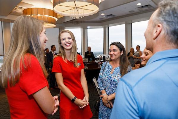 Capstone Women interact with families at an event